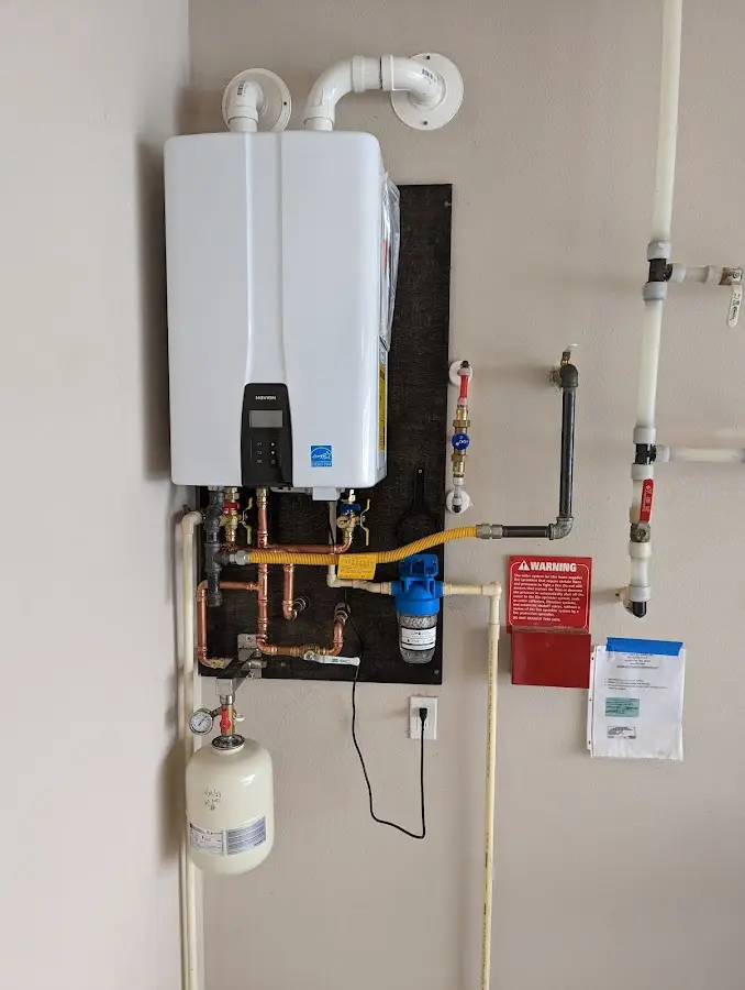 Professional plumber installing copper piping in a Seymour home